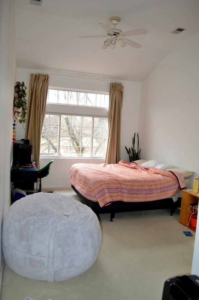bedroom with visible vents, ceiling fan, vaulted ceiling, and carpet floors