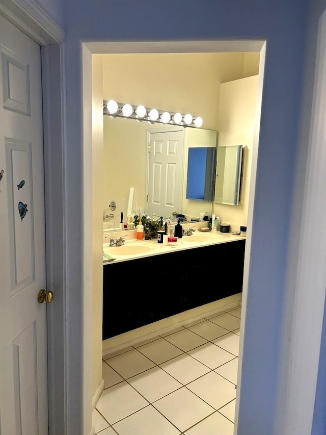 full bathroom featuring tile patterned floors, double vanity, and a sink