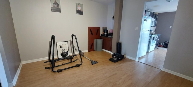 workout area with light hardwood / wood-style floors