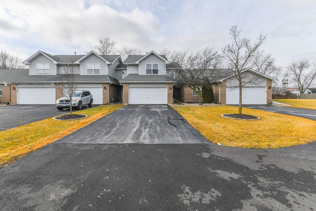 view of front of home featuring a garage and a front yard