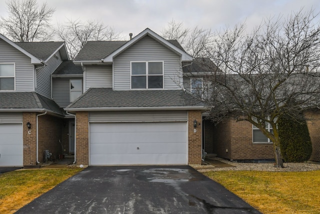 view of front of house with a garage and a front lawn