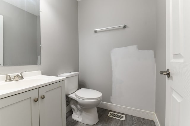 bathroom featuring vanity, toilet, and wood-type flooring