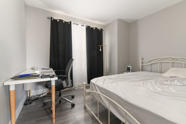 bedroom with dark hardwood / wood-style flooring