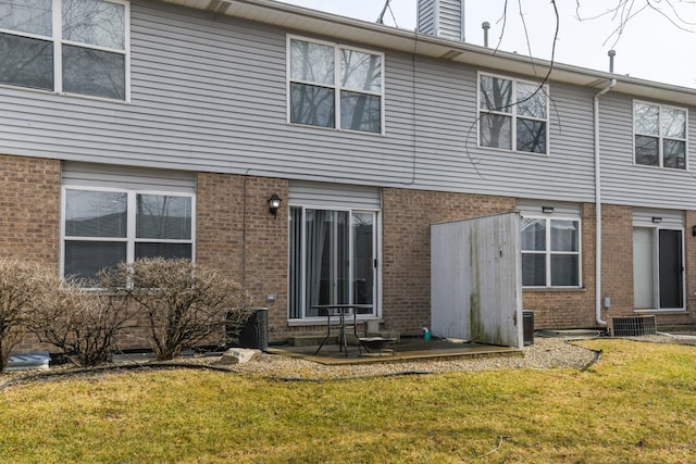 rear view of house featuring a yard, a patio area, and central air condition unit