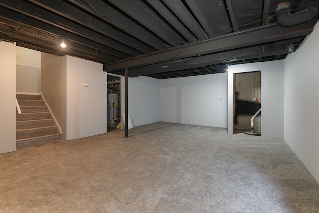 basement with water heater and carpet flooring