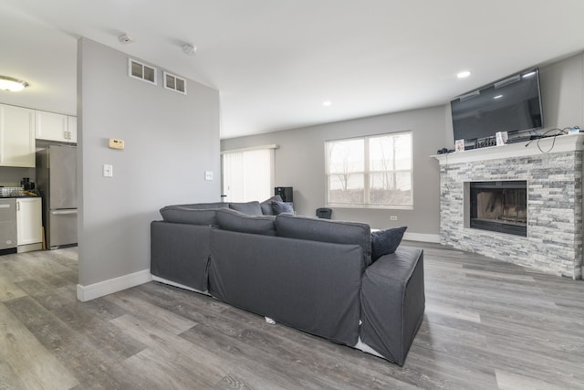 living room with hardwood / wood-style floors and a fireplace