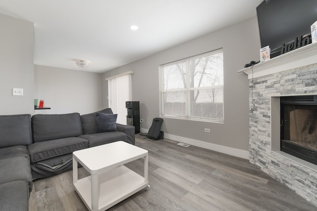 living room with hardwood / wood-style flooring and a fireplace