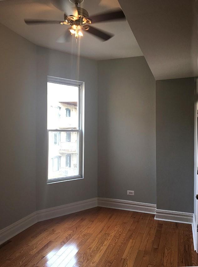 unfurnished room with ceiling fan and wood-type flooring