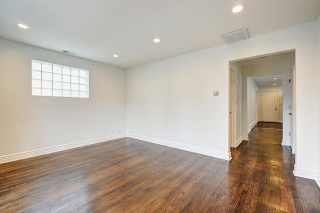 spare room featuring dark wood-type flooring