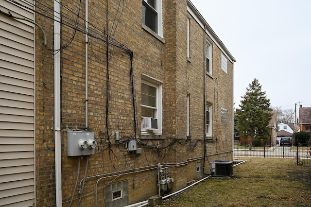 view of side of home featuring cooling unit and central air condition unit