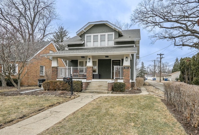 view of front facade with a front yard and covered porch