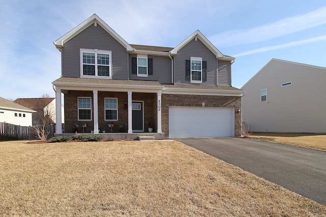 view of front of house with a garage, a front lawn, and a porch