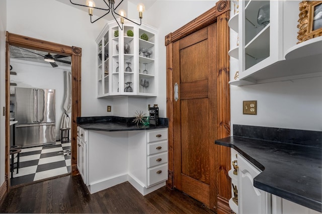 kitchen featuring ceiling fan, dark hardwood / wood-style floors, white cabinets, and stainless steel refrigerator