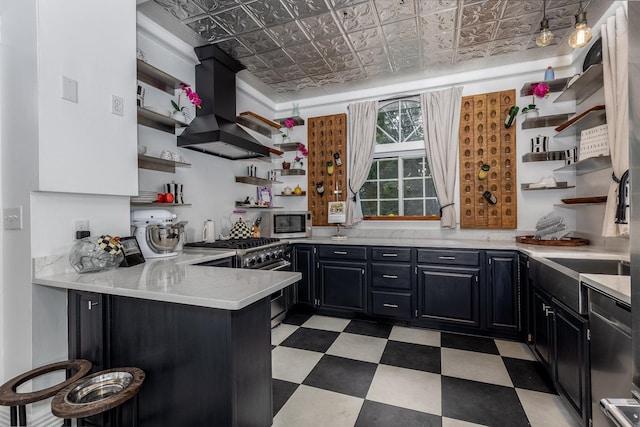 kitchen featuring a breakfast bar, stainless steel appliances, kitchen peninsula, and custom range hood