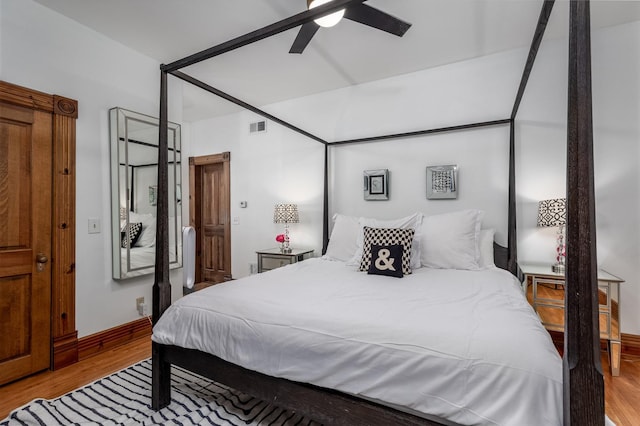 bedroom with ceiling fan and light hardwood / wood-style floors