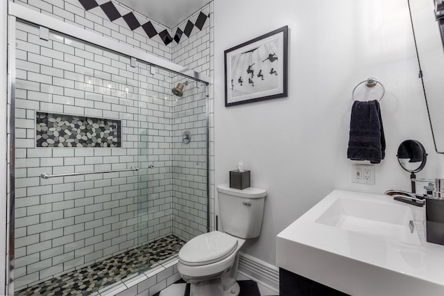 bathroom featuring vanity, toilet, and an enclosed shower