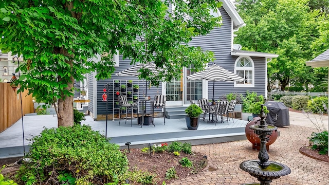 wooden deck featuring a grill