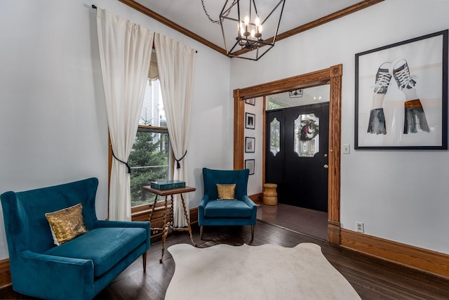 living area featuring ornamental molding, a notable chandelier, and dark hardwood / wood-style flooring