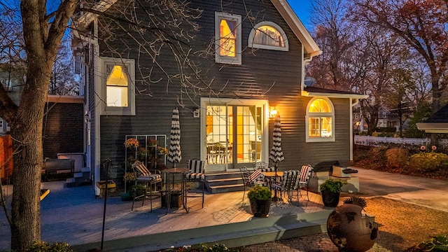 back of house featuring a patio and a wooden deck