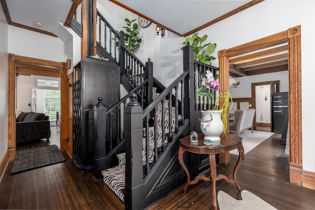 stairway with wood-type flooring and crown molding