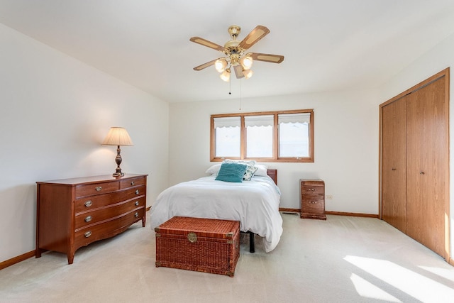 bedroom featuring baseboards, a ceiling fan, and light colored carpet