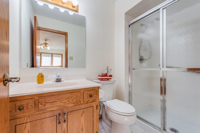 bathroom featuring a shower stall, vanity, and toilet