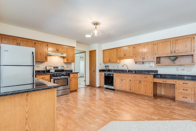 kitchen with black dishwasher, freestanding refrigerator, stainless steel gas range, open shelves, and a sink