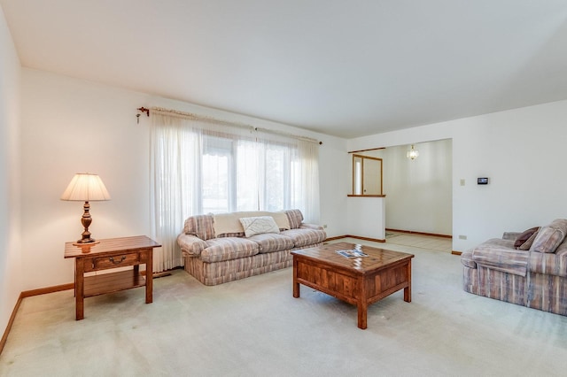 living room with baseboards and light colored carpet