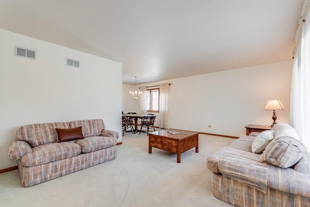 carpeted living room with baseboards, visible vents, and a chandelier