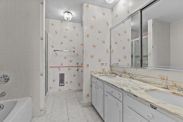 bathroom featuring double vanity, a sink, and tile patterned floors