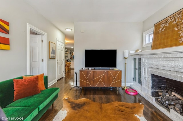 living room with a fireplace and dark hardwood / wood-style flooring