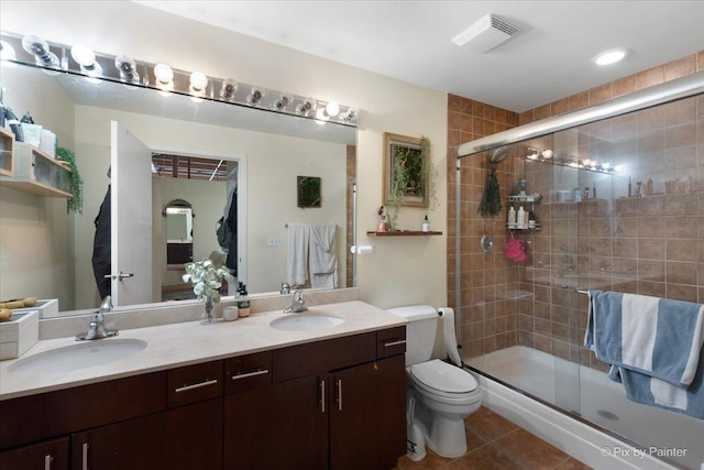 bathroom featuring vanity, toilet, an enclosed shower, and tile patterned flooring