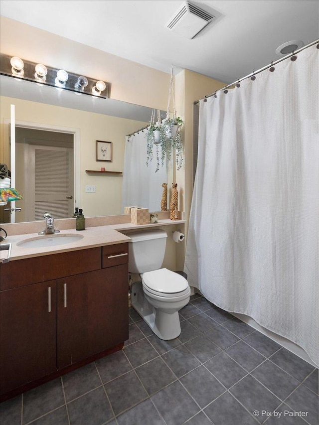 bathroom with tile patterned floors, toilet, and vanity