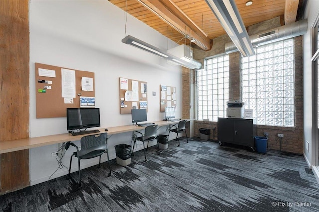 office featuring beam ceiling, built in desk, and wooden ceiling