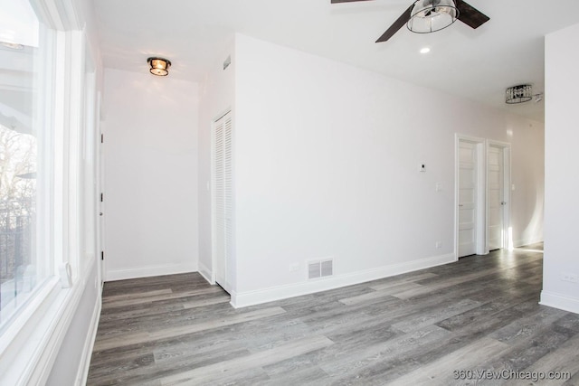 empty room with hardwood / wood-style flooring and ceiling fan