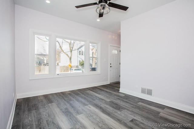 empty room with ceiling fan and dark hardwood / wood-style flooring