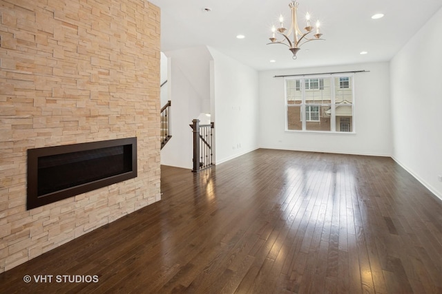 unfurnished living room featuring dark wood-type flooring and an inviting chandelier