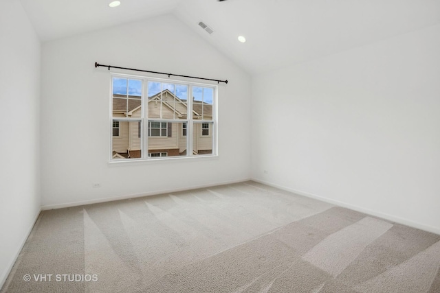 unfurnished room with lofted ceiling and carpet flooring