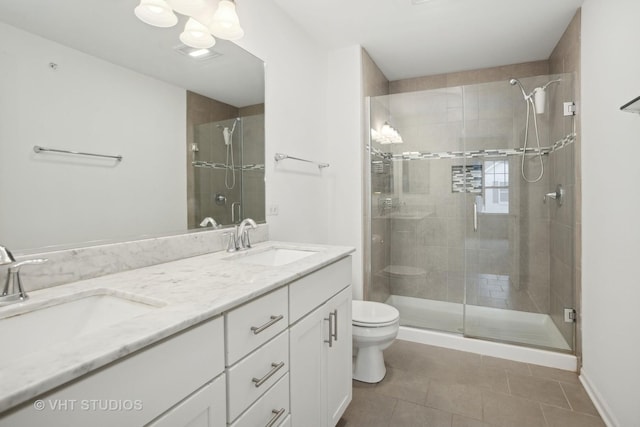 bathroom featuring vanity, tile patterned flooring, a shower with shower door, and toilet