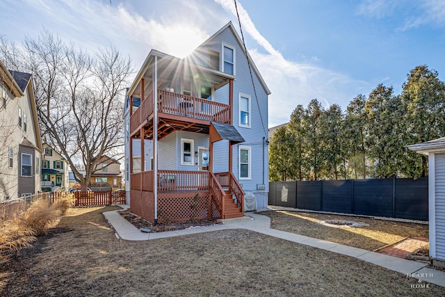 rear view of house featuring a wooden deck