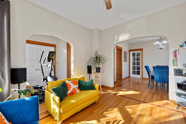 living room featuring an inviting chandelier and light hardwood / wood-style flooring