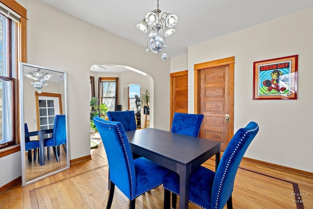 dining room featuring a notable chandelier and light hardwood / wood-style flooring