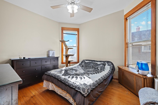 bedroom featuring ceiling fan and light hardwood / wood-style flooring