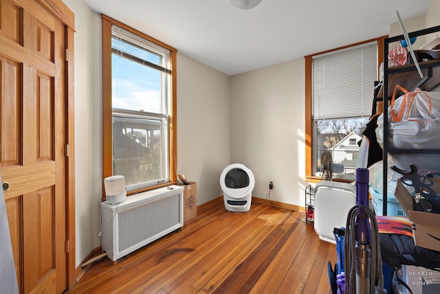 interior space with hardwood / wood-style flooring and radiator heating unit