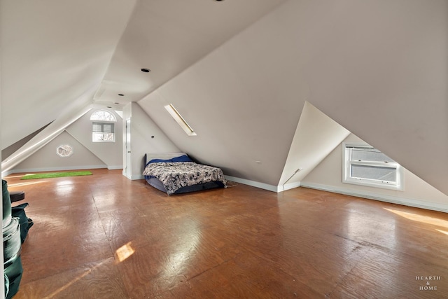 unfurnished bedroom with lofted ceiling and hardwood / wood-style floors