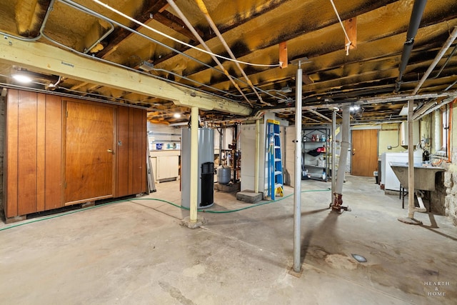 basement with water heater, sink, and washer / clothes dryer