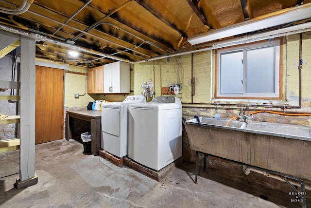 laundry area featuring washing machine and dryer and cabinets