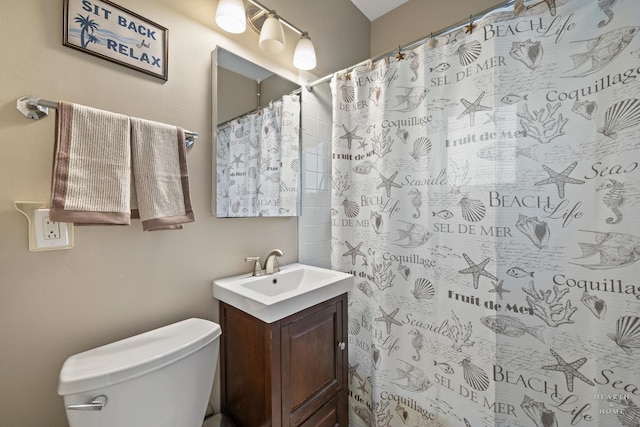 bathroom with vanity, toilet, and walk in shower