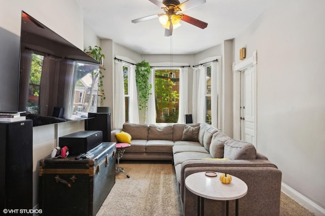 living room with ceiling fan and carpet flooring