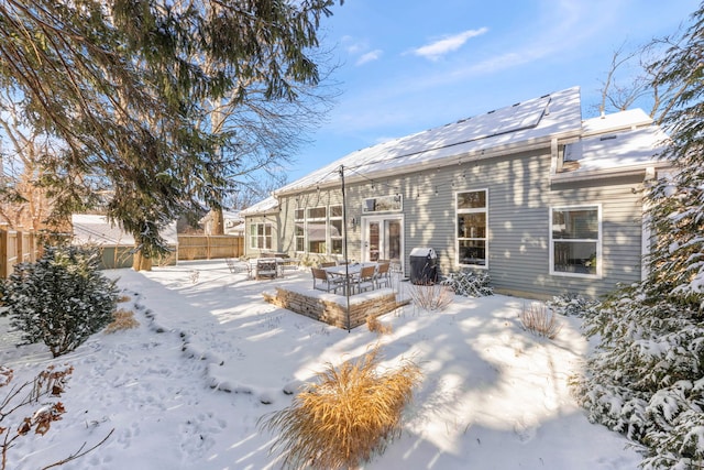 snow covered house featuring a fire pit